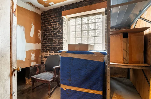 a living room with a bed furniture and a window