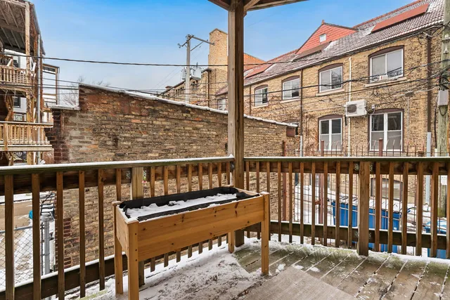 a balcony with a bench next to a yard