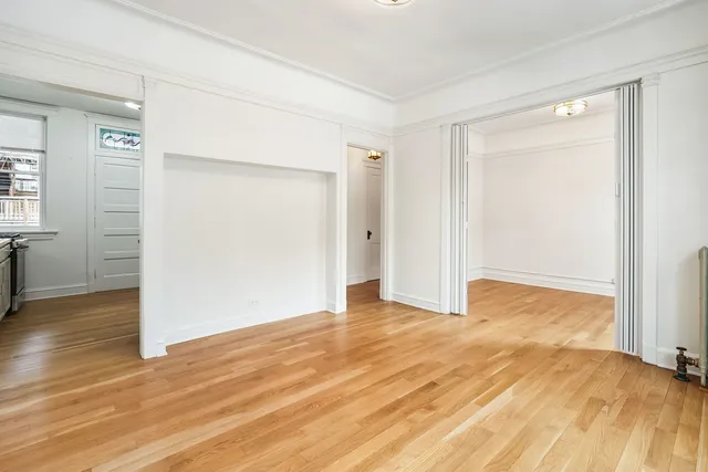 a view of an empty room with wooden floor