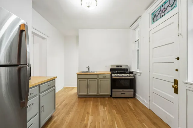 a kitchen with a sink and a stove top oven
