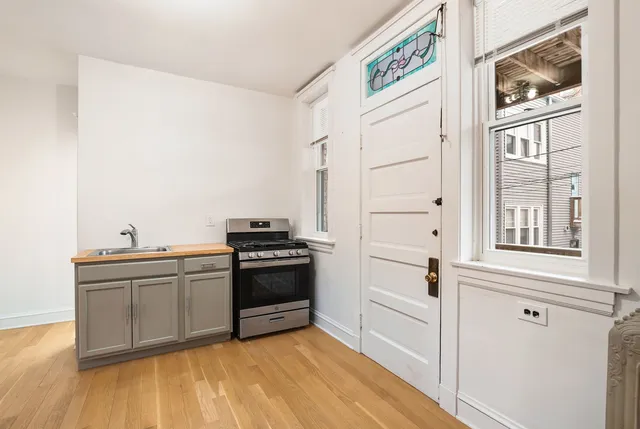 a kitchen with stainless steel appliances granite countertop a stove and a refrigerator
