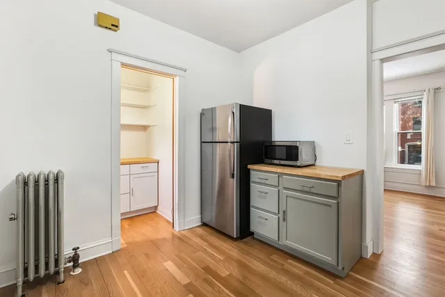 a kitchen with a refrigerator sink and cabinets