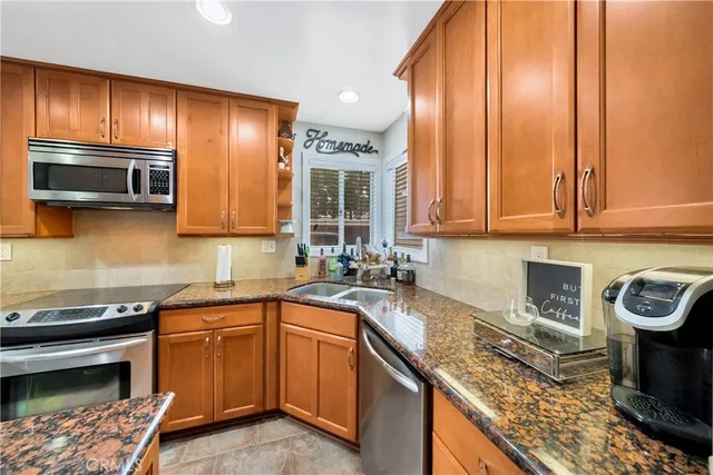 a kitchen with a sink a stove and cabinets