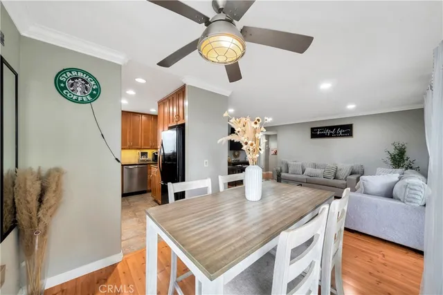 a view of a dining room with furniture and wooden floor