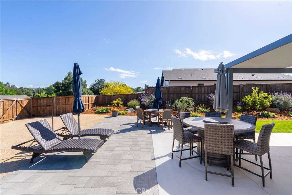 8550 El Corte Road Atascadero, CA 93422 - Photo 50 of 72 a view of a patio with a dining table and chairs with two plants