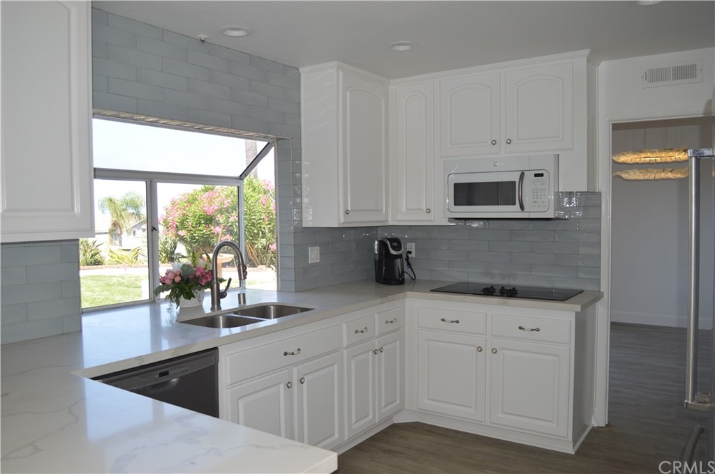 2139 Via Aguila San Clemente, CA 92673 - Photo 11 of 34 a kitchen with appliances a sink and a window