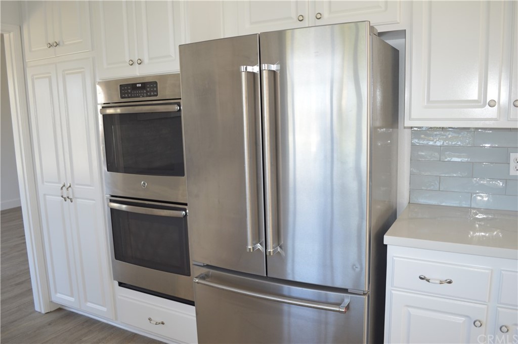 2139 Via Aguila San Clemente, CA 92673 - Photo 12 of 34 a metallic refrigerator freezer sitting in a kitchen