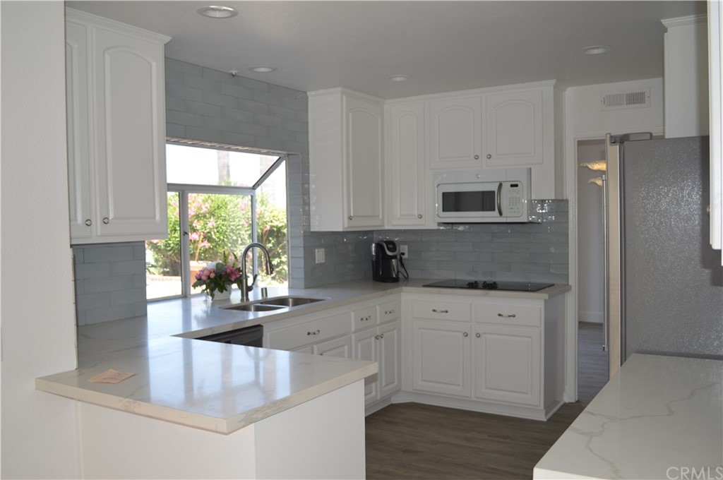 2139 Via Aguila San Clemente, CA 92673 - Photo 9 of 34 a kitchen with stainless steel appliances granite countertop a stove a sink and a refrigerator
