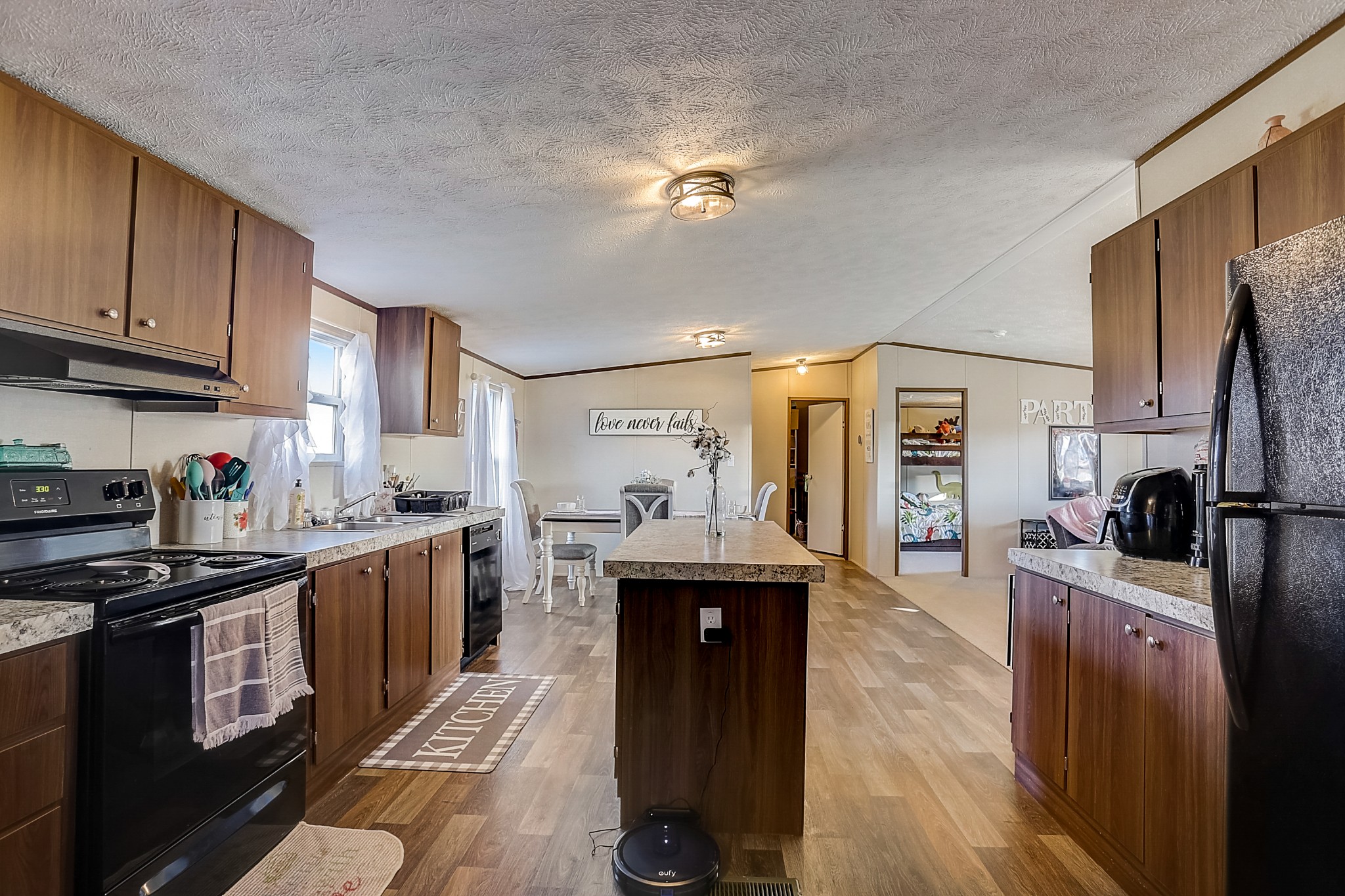 4249 Red Boiling Springs Road Lafayette, TN 37083 - Photo 6 of 16 a kitchen with stainless steel appliances granite countertop a sink stove and refrigerator
