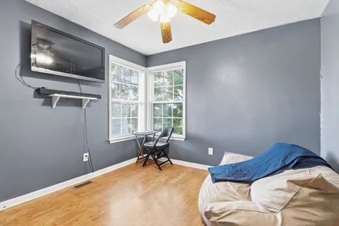 a bedroom with a bed and a window