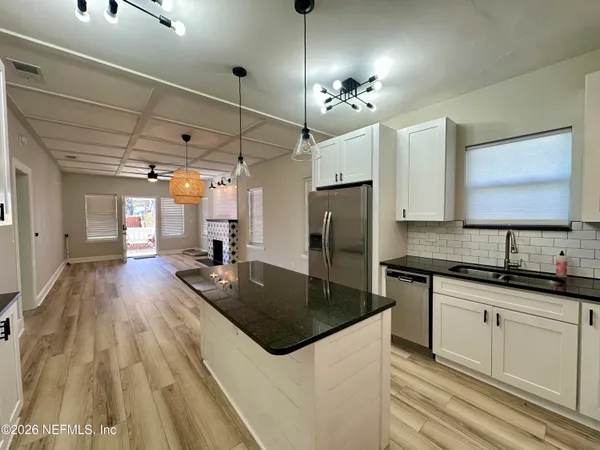 a kitchen with refrigerator a sink and cabinets
