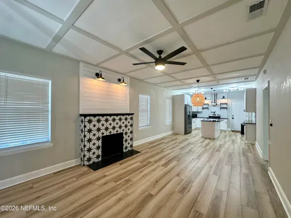 a room with wooden floor and furniture