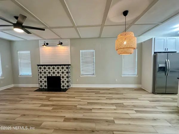 a view of an empty room with a fireplace