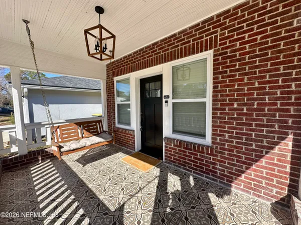 a view of a balcony with two chairs and wooden floor