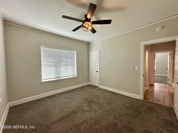 a view of a livingroom with a ceiling fan and window
