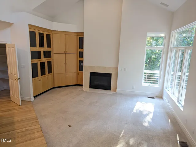 a view of empty room with windows and white walls