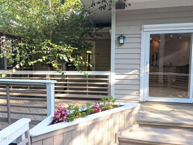 a view of a house with a window and wooden fence