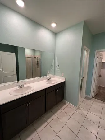 a bathroom with a double vanity sink mirror and double