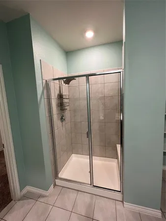 a bathroom with a glass door shower
