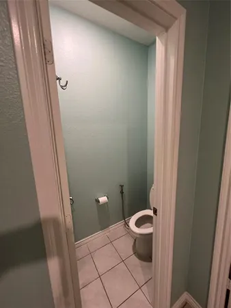 a bathroom with a granite countertop toilet and a sink