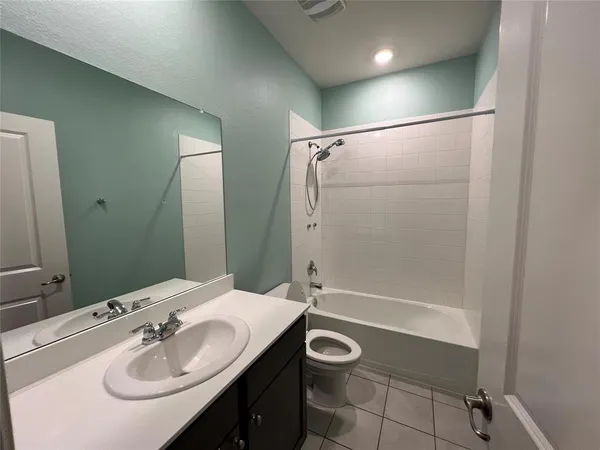 a bathroom with a sink mirror vanity and toilet