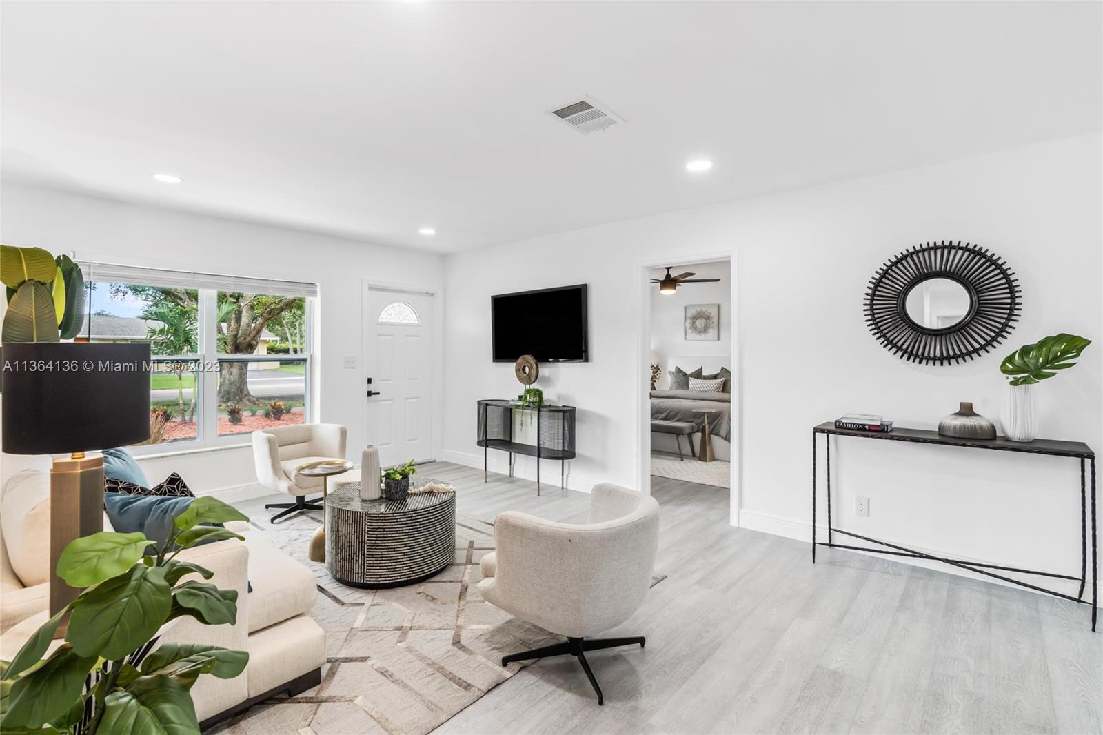 7321 Northwest 11th Place Plantation, FL 33313 - Photo 1 of 23 a living room with furniture a flat screen tv and kitchen view