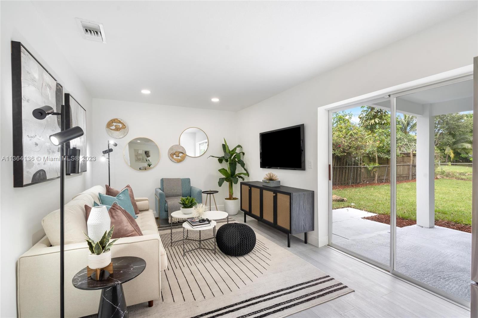 7321 Northwest 11th Place Plantation, FL 33313 - Photo 11 of 23 a living room with furniture and a flat screen tv