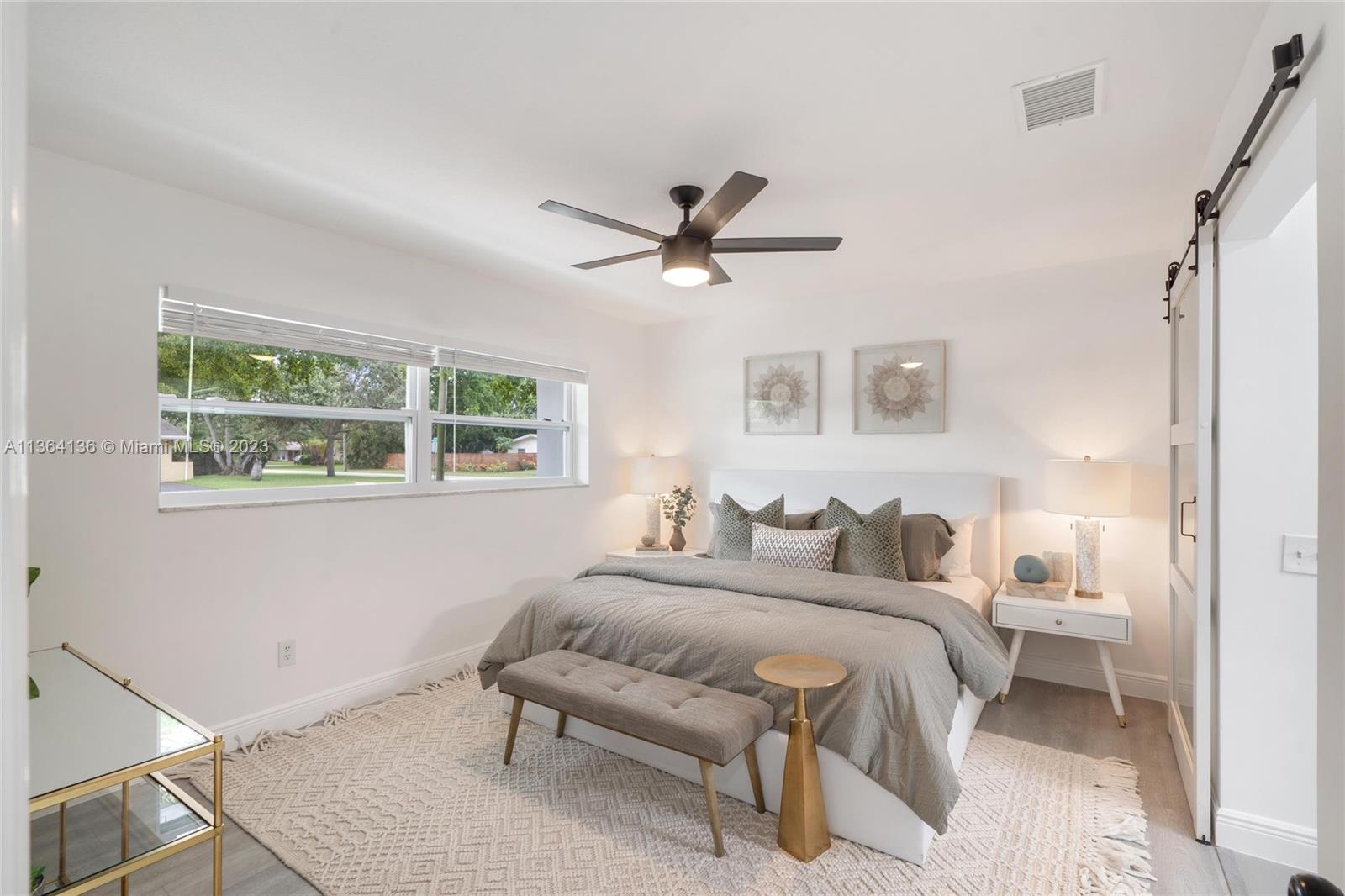 7321 Northwest 11th Place Plantation, FL 33313 - Photo 13 of 23 a bedroom with a bed and a window