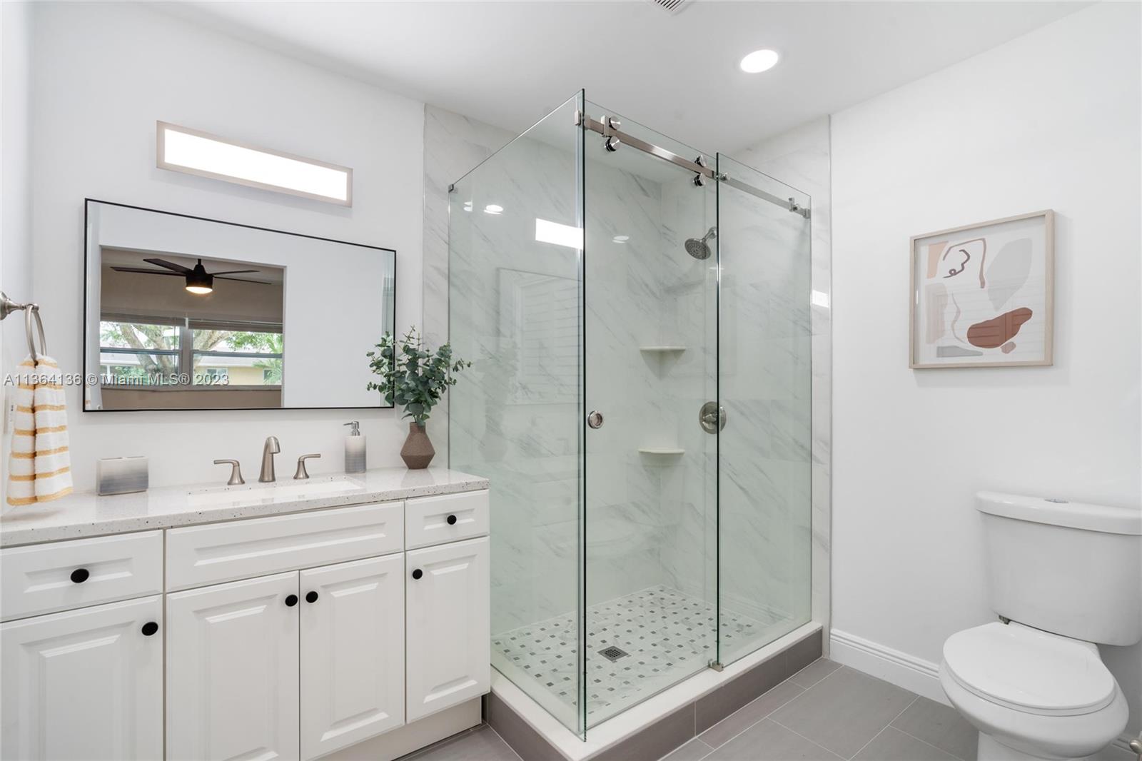 7321 Northwest 11th Place Plantation, FL 33313 - Photo 14 of 23 a bathroom with a shower sink mirror and toilet