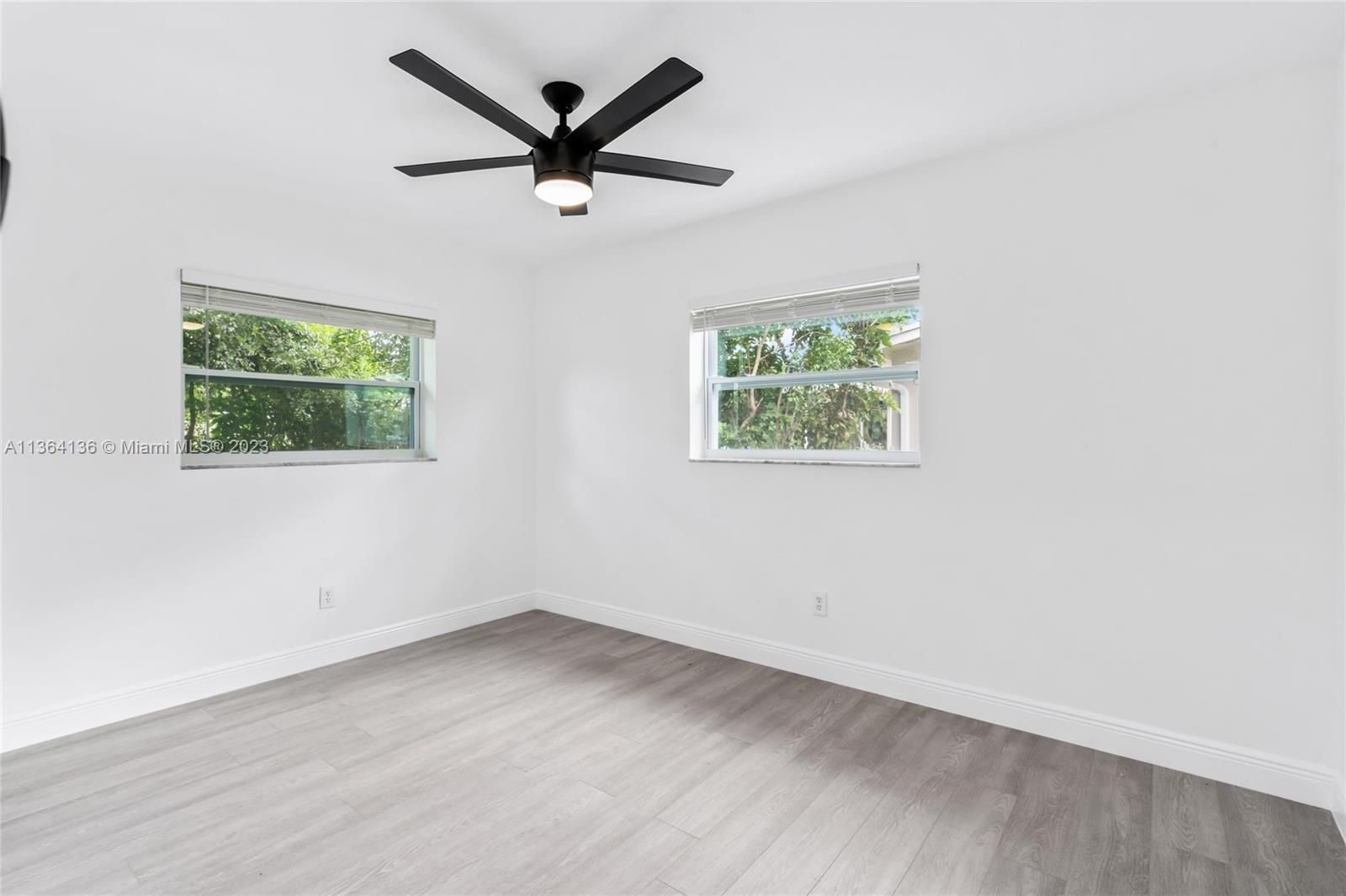 7321 Northwest 11th Place Plantation, FL 33313 - Photo 16 of 23 an empty room with wooden floor and windows