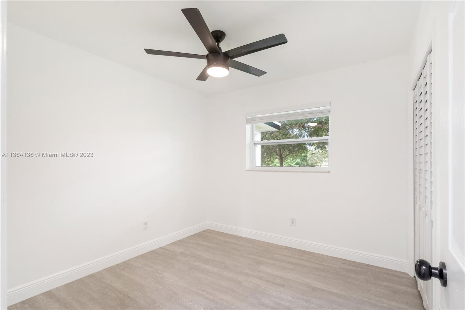 7321 Northwest 11th Place Plantation, FL 33313 - Photo 18 of 23 an empty room with a window and a ceiling fan
