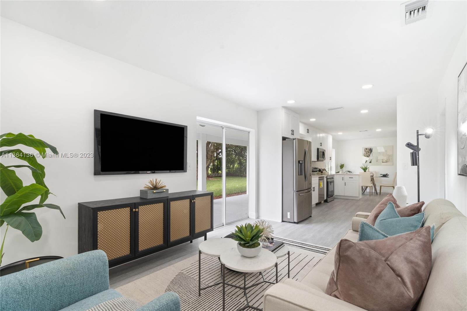 7321 Northwest 11th Place Plantation, FL 33313 - Photo 4 of 23 a living room with furniture and a flat screen tv