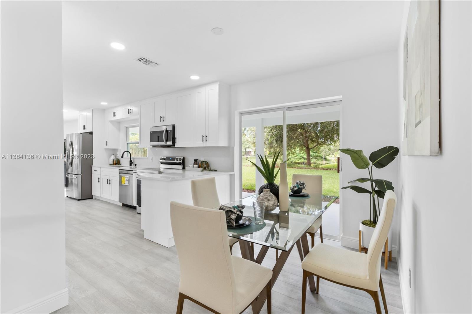 7321 Northwest 11th Place Plantation, FL 33313 - Photo 6 of 23 a view of a kitchen with dining table and chairs