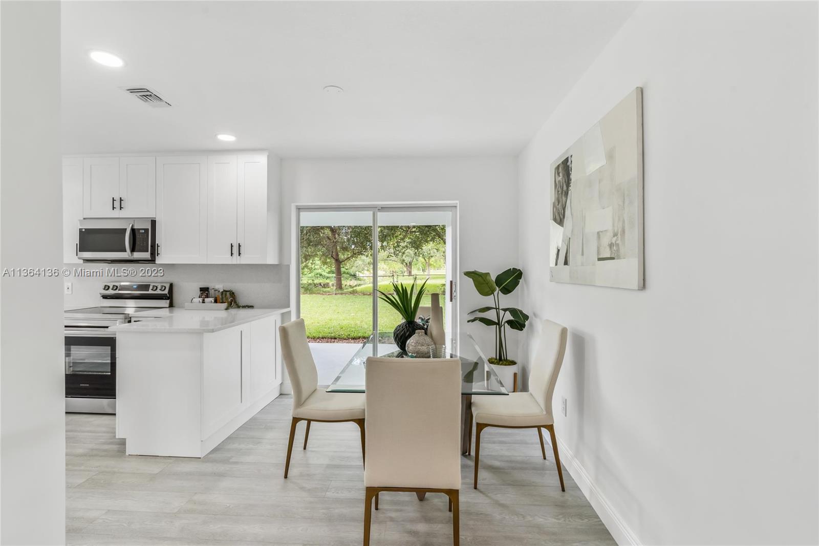 7321 Northwest 11th Place Plantation, FL 33313 - Photo 7 of 23 a view of a dining room with furniture a fireplace and wooden floor