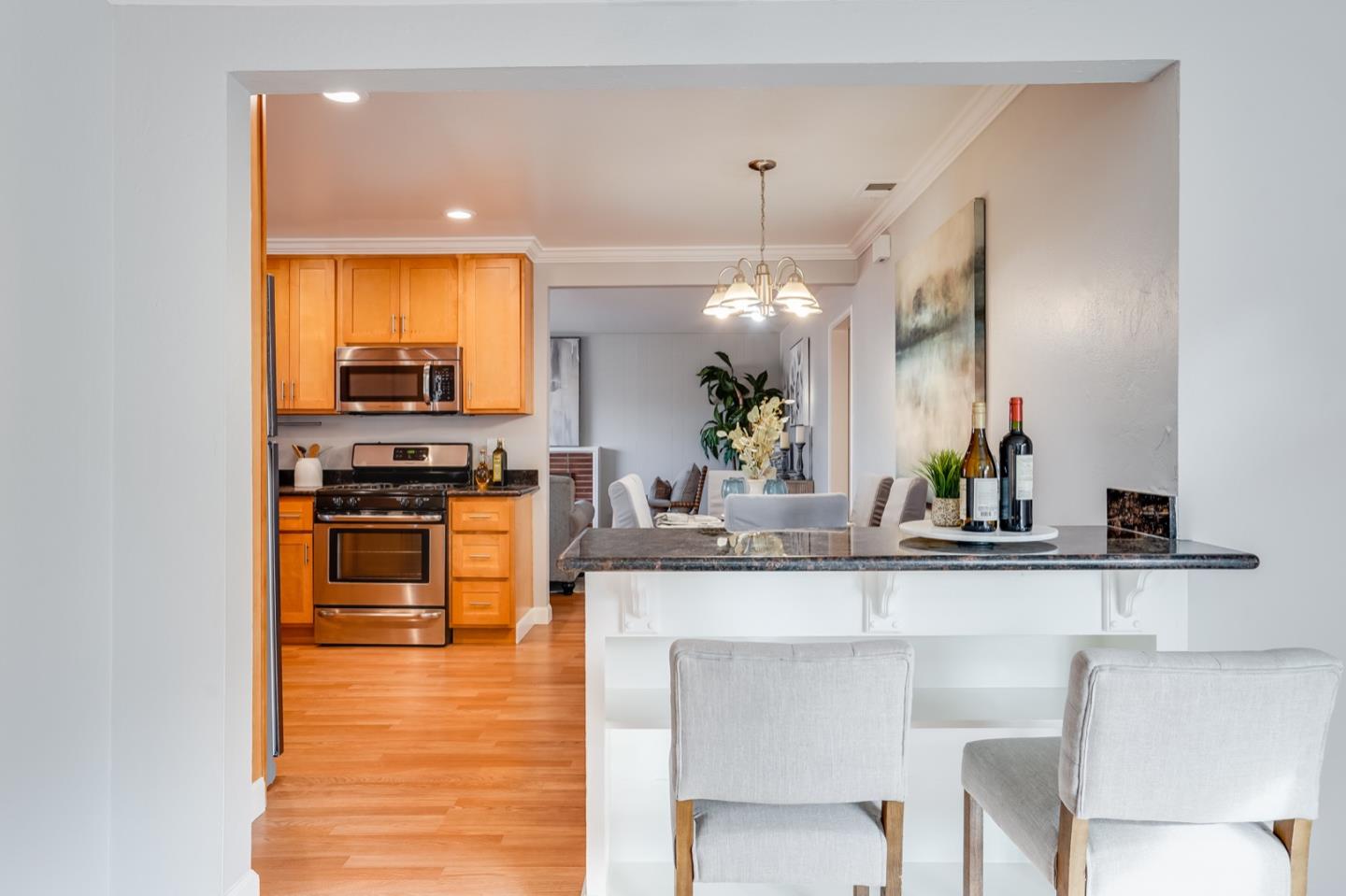 2101 Briarwood Drive Santa Clara, CA 95051 - Photo 12 of 41 a kitchen with stainless steel appliances kitchen island granite countertop a sink and cabinets