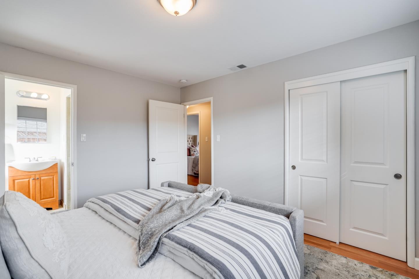 2101 Briarwood Drive Santa Clara, CA 95051 - Photo 22 of 41 a bedroom with a bed and wooden floor