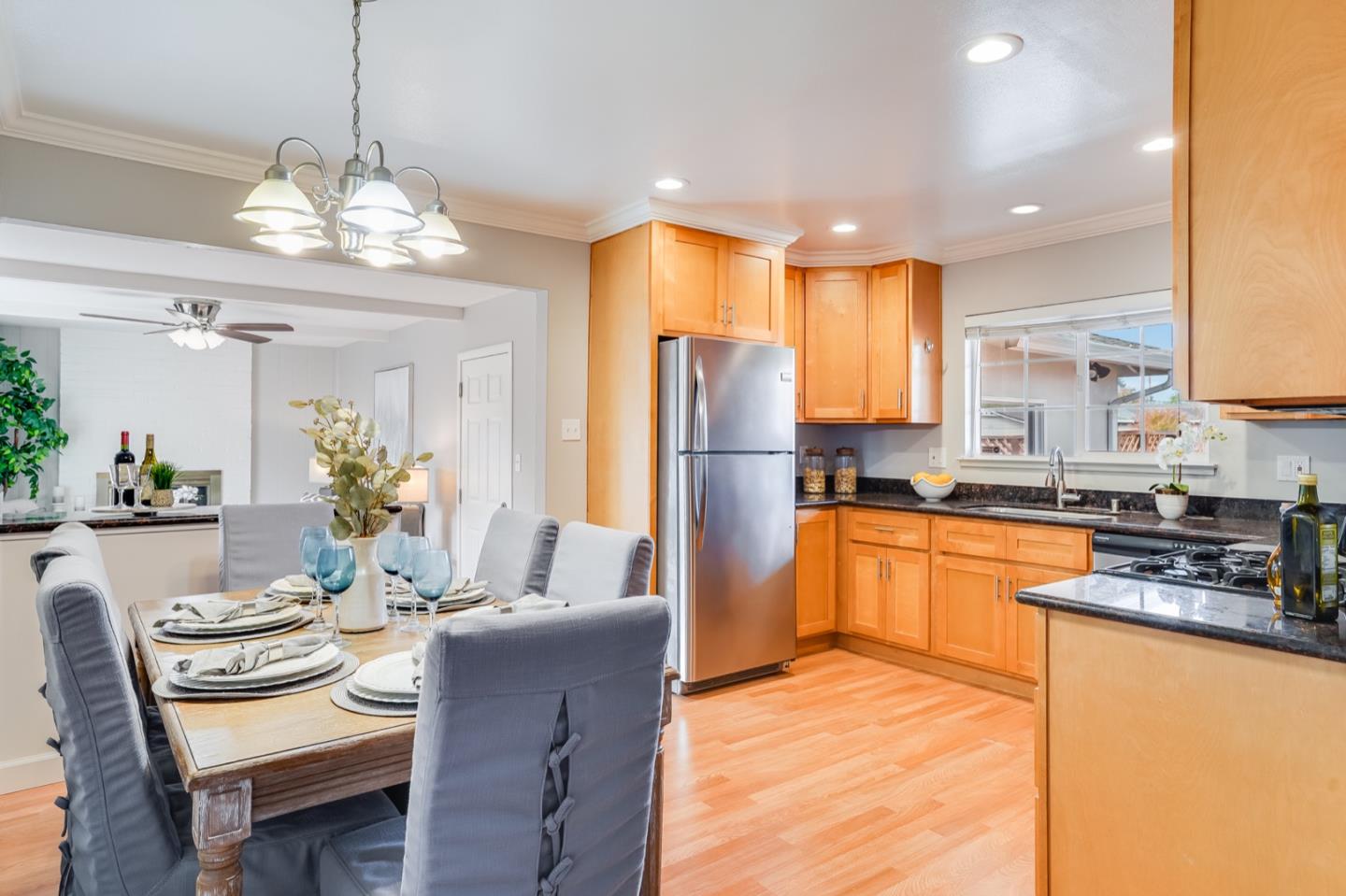 2101 Briarwood Drive Santa Clara, CA 95051 - Photo 6 of 41 a kitchen with stainless steel appliances granite countertop a refrigerator a sink dishwasher a dining table and chairs with wooden floor