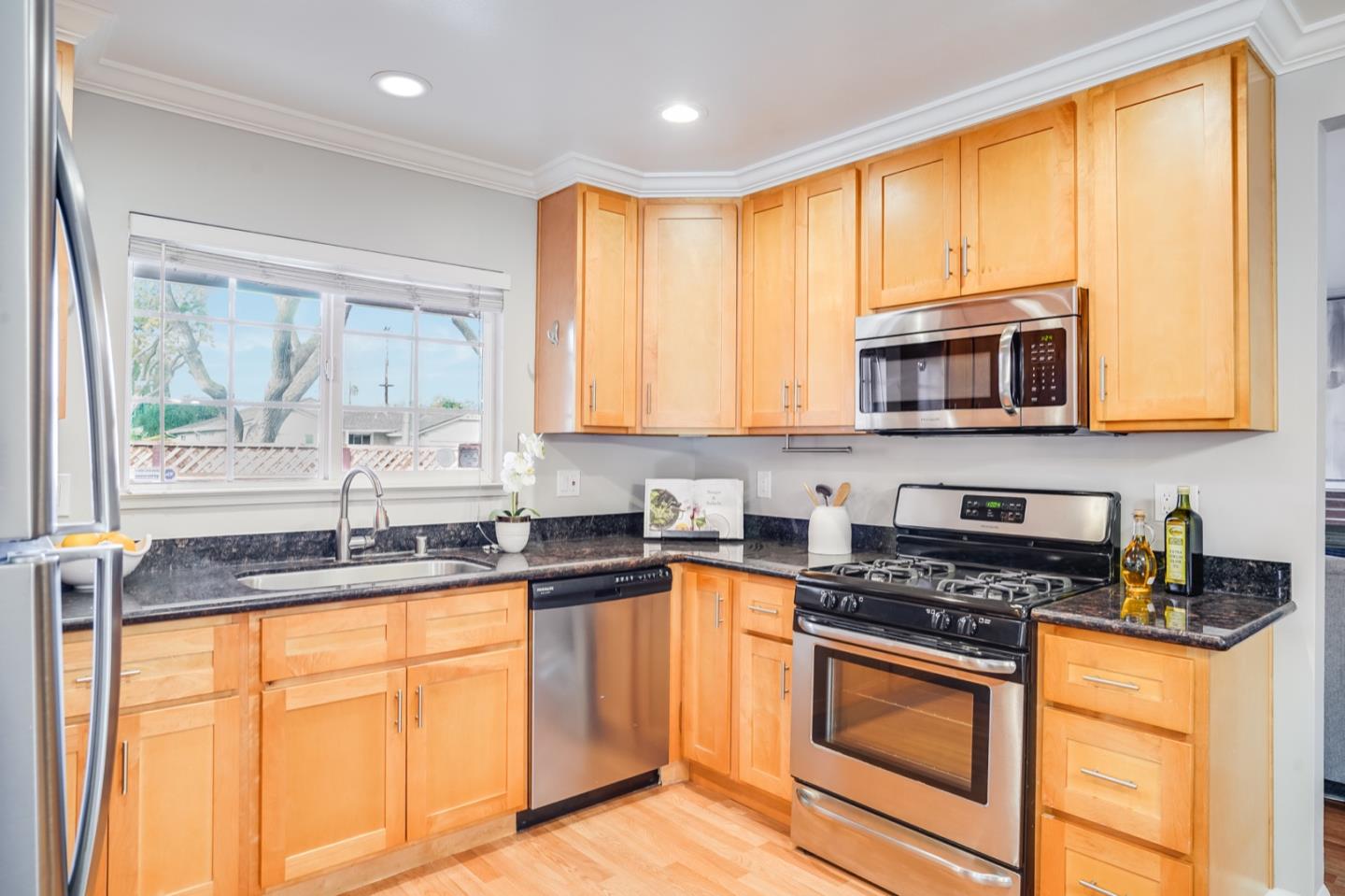 2101 Briarwood Drive Santa Clara, CA 95051 - Photo 7 of 41 a kitchen with granite countertop a stove top oven sink and cabinets