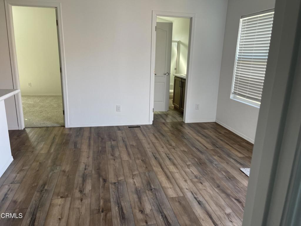 1908 B Sorrel Street Camarillo, CA 93010 - Photo 7 of 11 an empty room with wooden floor and windows