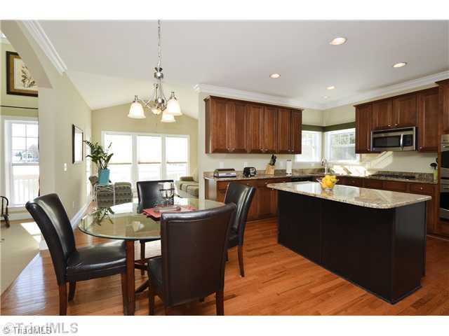 8509 Julina Drive Oak Ridge, NC 27310 - Photo 7 of 16 Kitchen. Breakfast area with sunroom behind