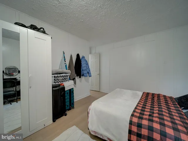 a bedroom with a bed and a walk in closet