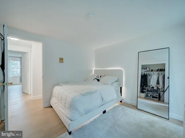 a bedroom with a bed and a mirror