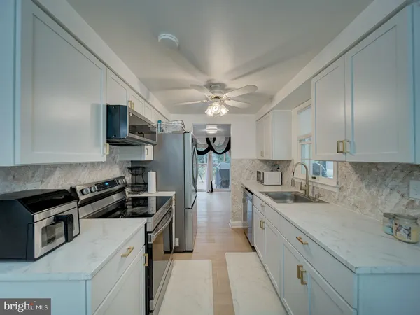 a kitchen with a sink stove and refrigerator