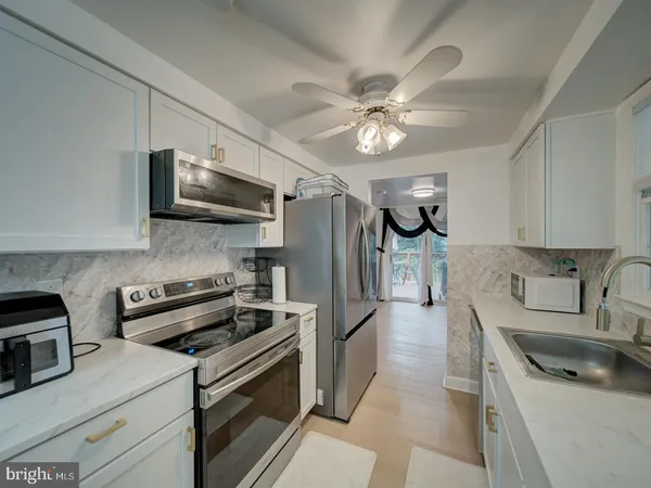 a kitchen with stainless steel appliances a sink stove and refrigerator