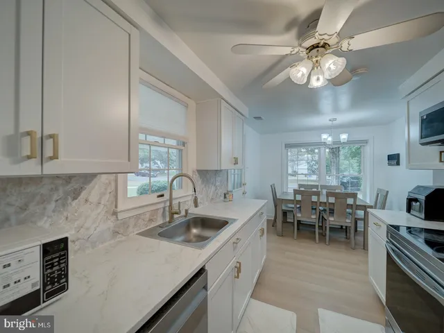 a kitchen with furniture a sink a stove and cabinets