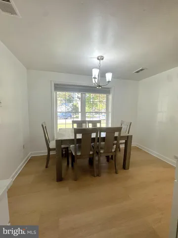 a view of a dining room with furniture and chandelier