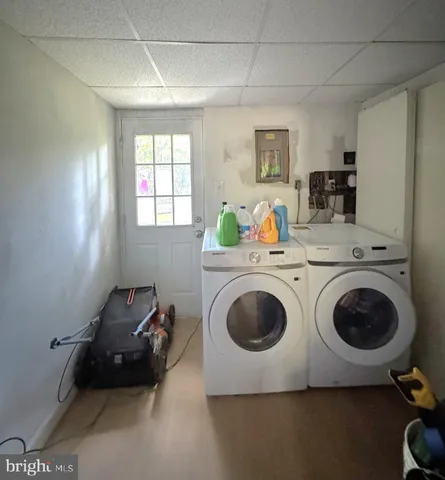 a utility room with dryer washer and a window