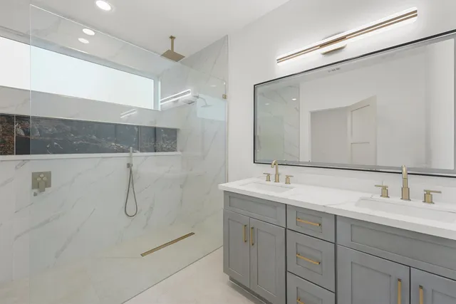 a bathroom with a double vanity sink mirror and double