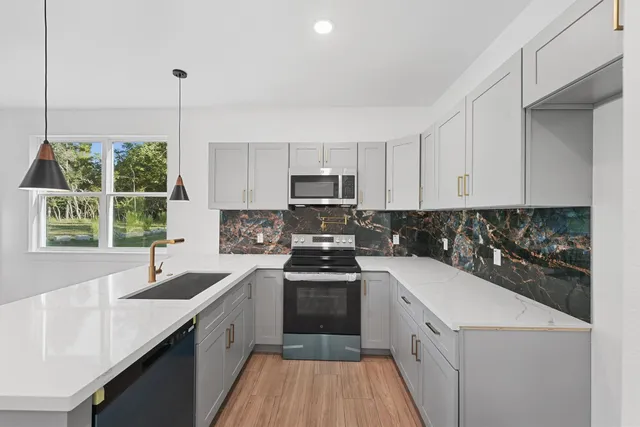 a kitchen with a sink stove and cabinets