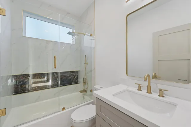 a bathroom with a sink toilet and shower